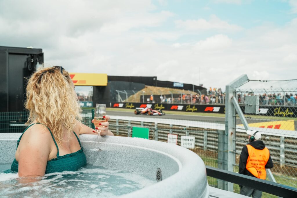 Guest enjoying HSG282 compliant commercial hot tub hire UK at Silverstone event trackside