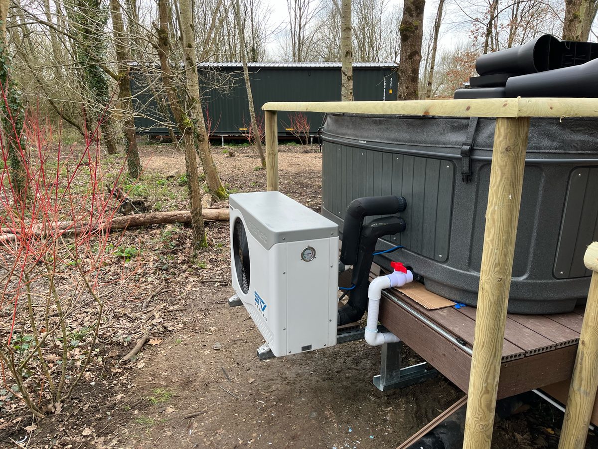 Woodland lodge hot tub — heat pump with insulated bypass and service access